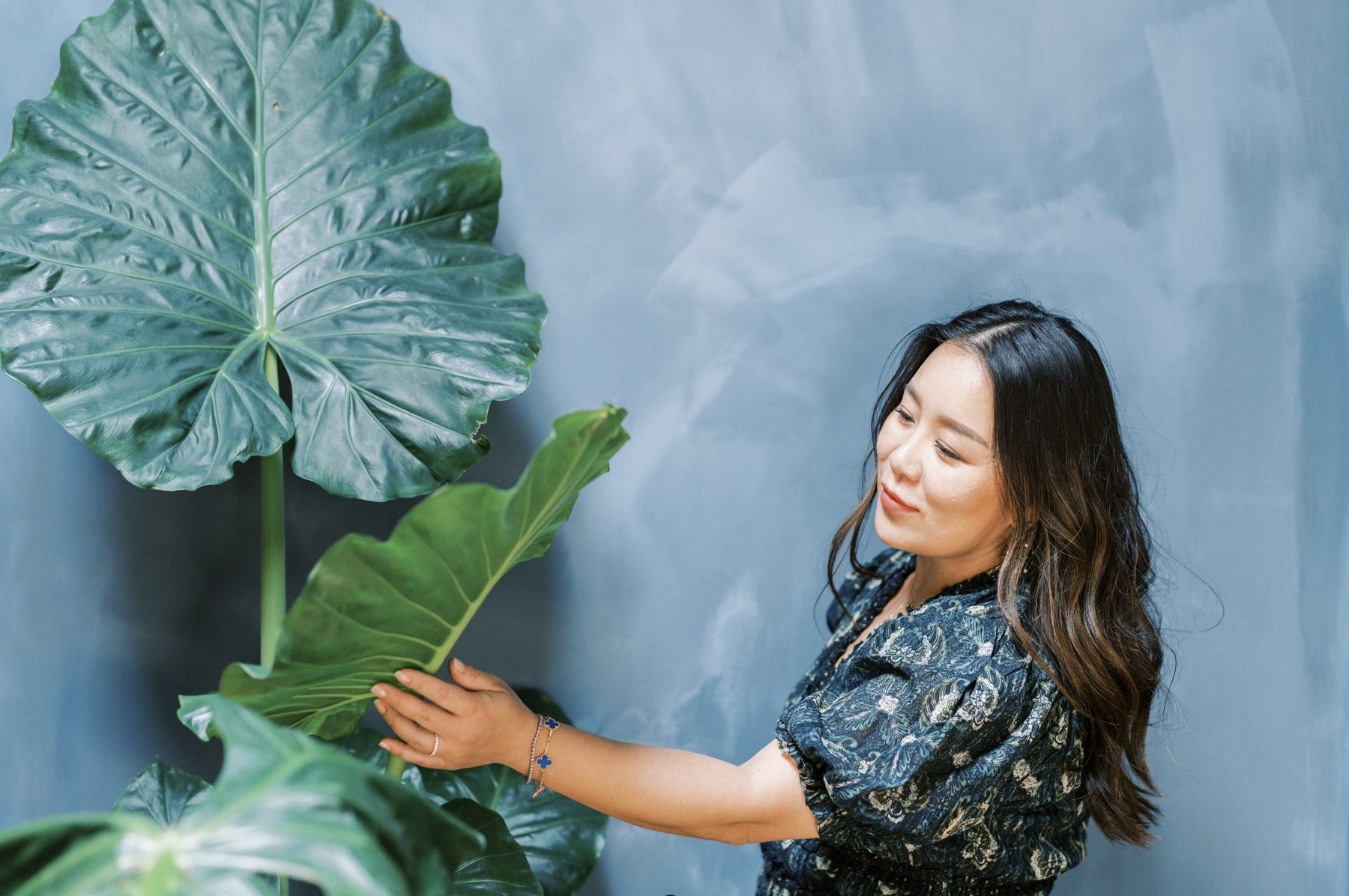 Founder holding a large tropical leaf